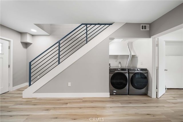3721 S San Pedro St, Los Angeles, CA 90011 - clothes washing area featuring recessed lighting, wood finished floors, visible vents, baseboards, and washer and dryer
