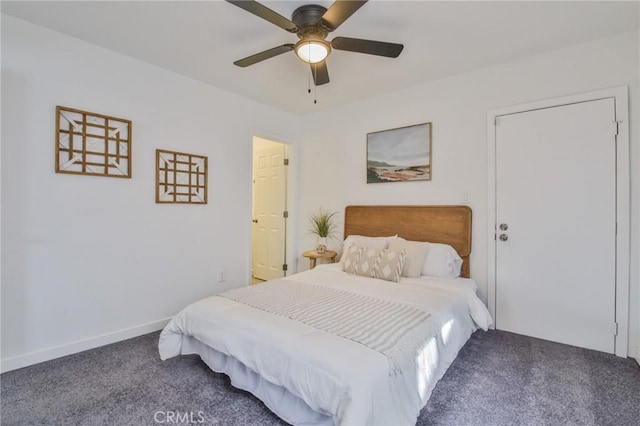 carpeted bedroom with a ceiling fan and baseboards