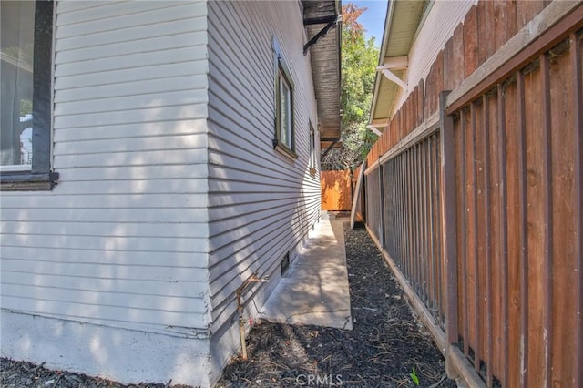 view of side of property featuring fence