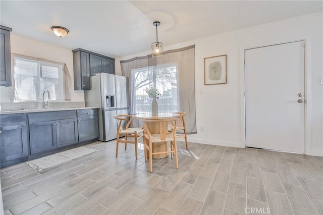 dining room featuring baseboards and light wood-style floors