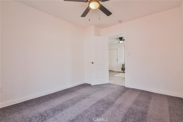 empty room with a ceiling fan, baseboards, and carpet floors