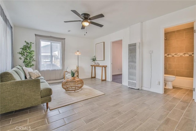 living area featuring a ceiling fan and a heating unit