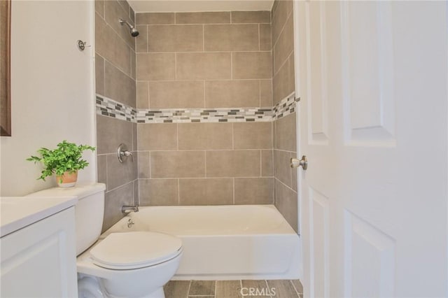 bathroom featuring shower / bathing tub combination, toilet, and vanity