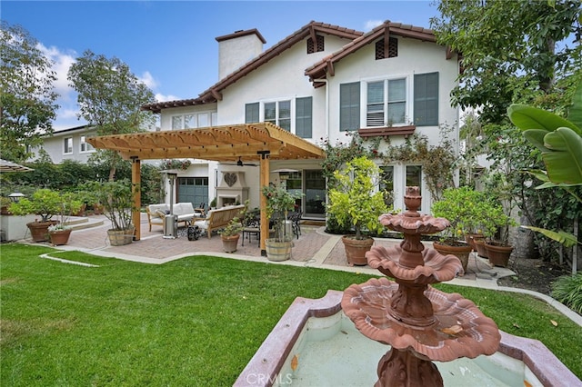 rear view of house with stucco siding, a pergola, a lawn, and a patio
