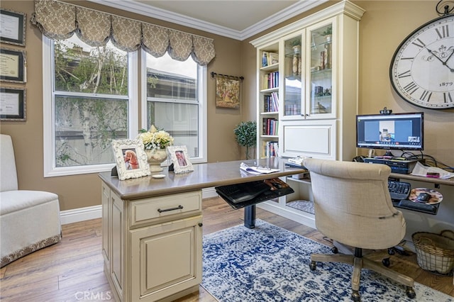 office space featuring light wood-style flooring, baseboards, and ornamental molding