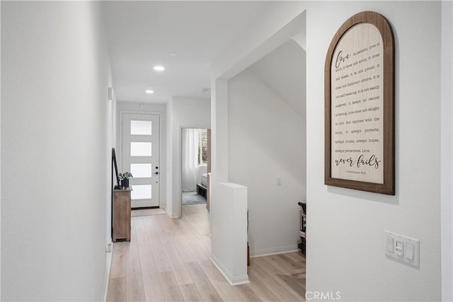 hallway featuring recessed lighting, baseboards, and light wood-style floors