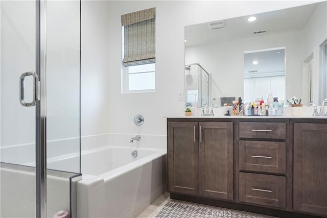 bathroom featuring double vanity, a stall shower, a bath, and visible vents