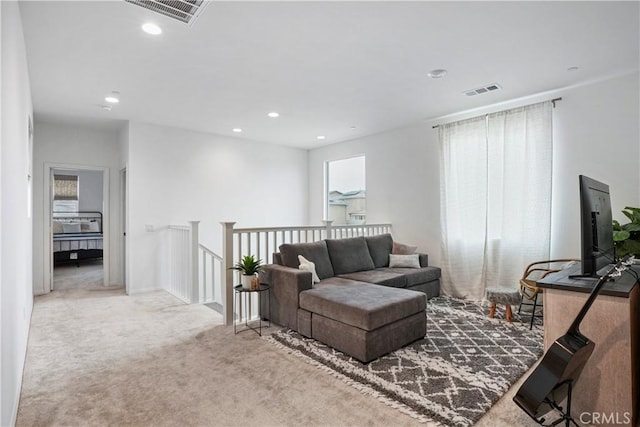 living area featuring recessed lighting, visible vents, a wealth of natural light, and carpet