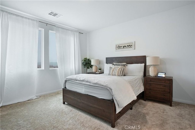 carpeted bedroom with baseboards and visible vents