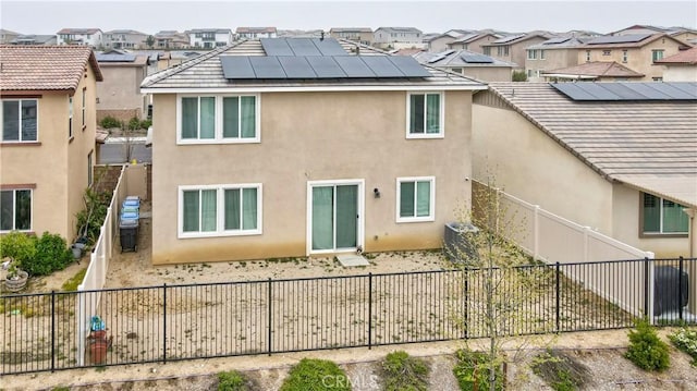 back of property with a fenced backyard and stucco siding