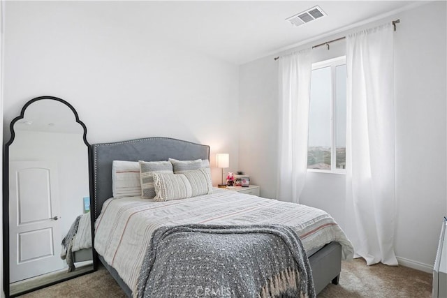 bedroom with visible vents, carpet flooring, and multiple windows