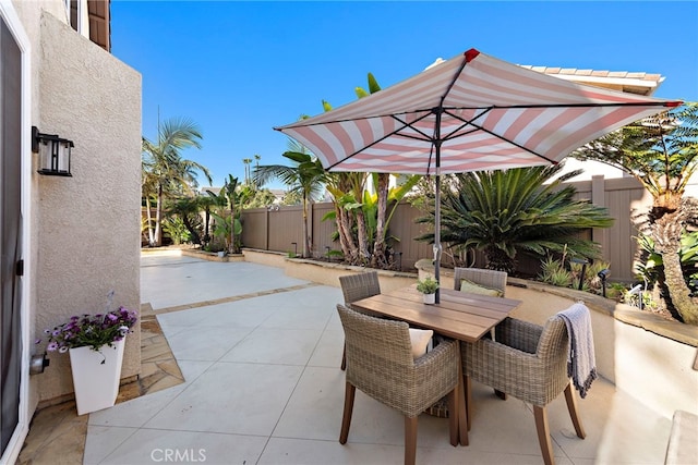 view of patio / terrace with outdoor dining space and a fenced backyard