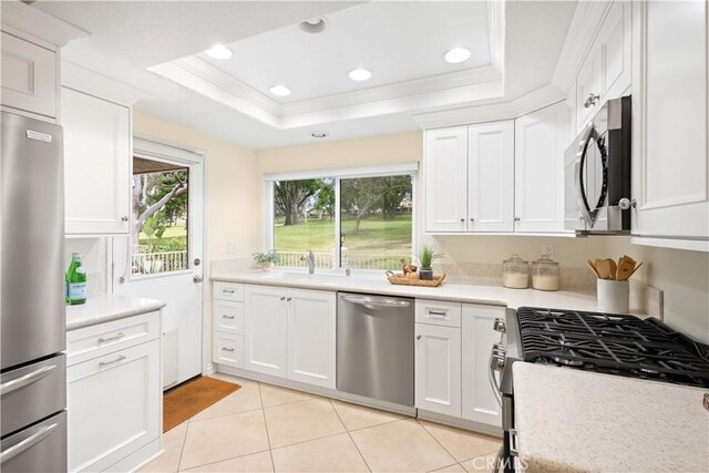1061 Pebble Beach Dr, Upland, CA 91784 - kitchen featuring a sink, stainless steel appliances, a raised ceiling, crown molding, and light countertops