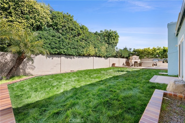 view of yard with area for grilling, a patio, and a fenced backyard