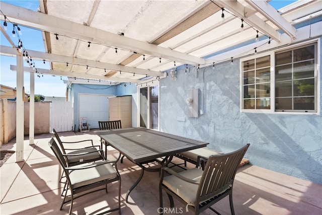 view of patio featuring fence, a pergola, and outdoor dining area