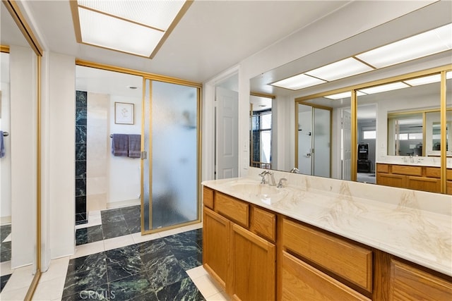 bathroom featuring a shower stall and vanity