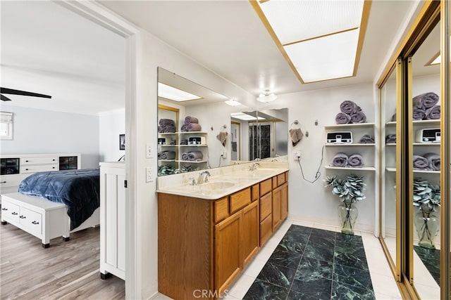 interior space featuring a ceiling fan and a sink