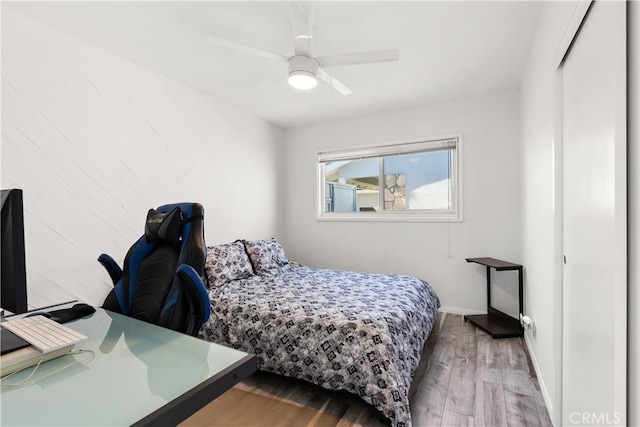 bedroom with baseboards, a ceiling fan, and wood finished floors