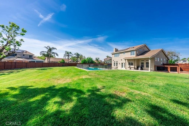 view of yard featuring a patio area, a fenced in pool, and a fenced backyard