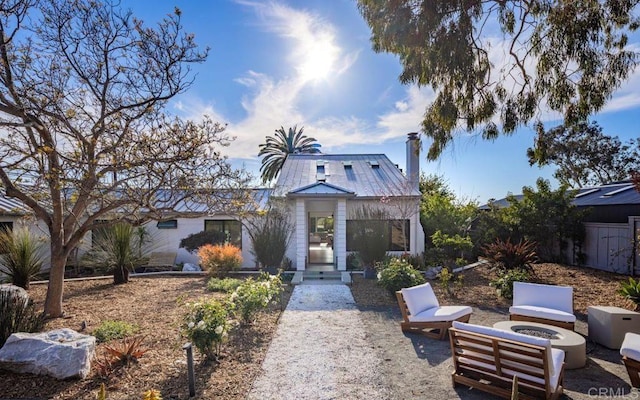 132628 Rainbow Ridge Ln, Encinitas, CA 92024 - view of front facade featuring a fire pit, a chimney, and metal roof