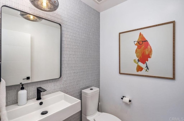 132628 Rainbow Ridge Ln, Encinitas, CA 92024 - half bathroom with tile walls, a sink, backsplash, and toilet