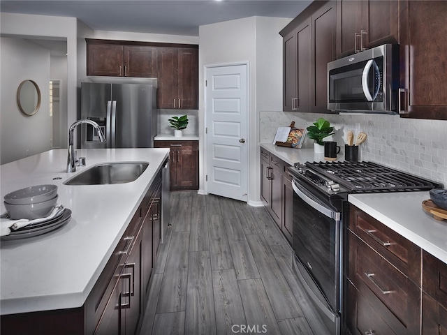35368 Garcia St, Beaumont, CA 92223 - kitchen with a sink, stainless steel appliances, light countertops, dark wood finished floors, and backsplash