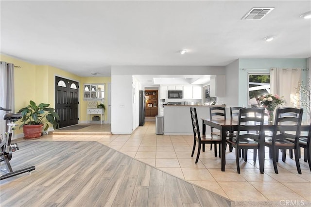dining area with visible vents and light tile patterned floors
