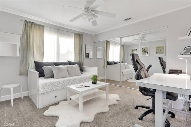 bedroom with crown molding, light colored carpet, a ceiling fan, visible vents, and a closet