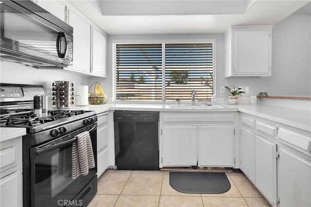 kitchen featuring white cabinets, light tile patterned floors, and black appliances