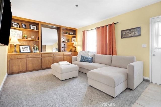 living area with light tile patterned flooring and baseboards