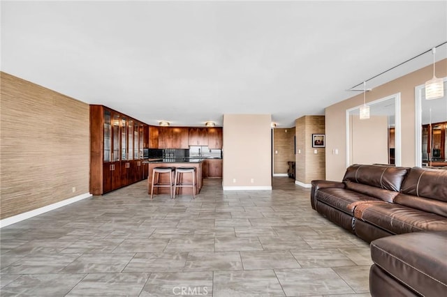 living area featuring baseboards