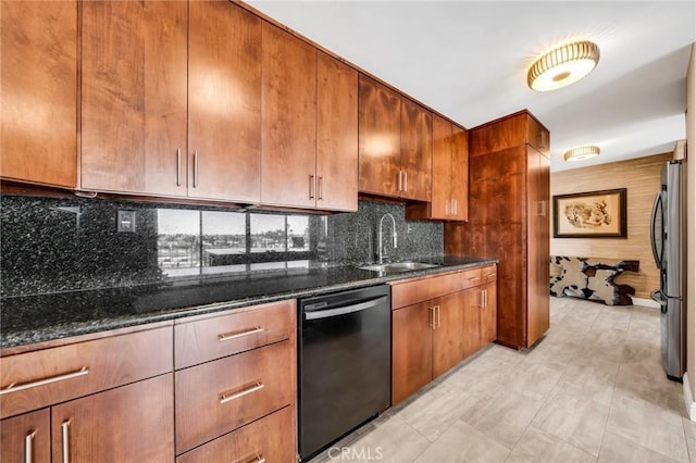 kitchen with freestanding refrigerator, dishwashing machine, decorative backsplash, and dark stone countertops