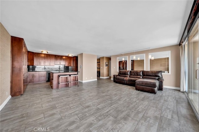 living area featuring baseboards and wood tiled floor