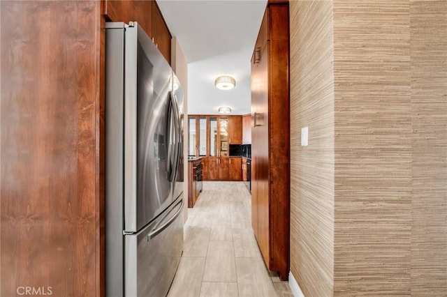 kitchen with stainless steel refrigerator with ice dispenser, modern cabinets, and brown cabinetry