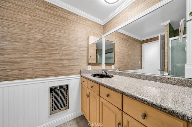 bathroom with wainscoting, ornamental molding, vanity, and visible vents