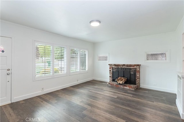 415 7th, Paso Robles, CA 93446 - unfurnished living room featuring baseboards, a wealth of natural light, dark wood-style flooring, and a brick fireplace