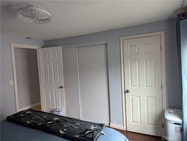bedroom with baseboards and a closet