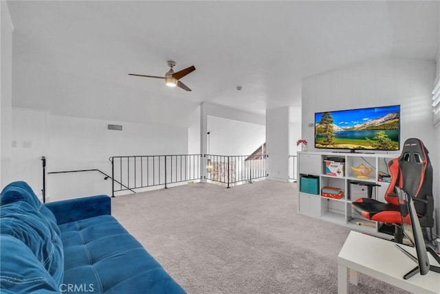 carpeted living area featuring vaulted ceiling, a ceiling fan, and visible vents