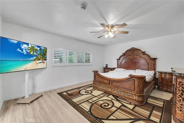 bedroom featuring baseboards, a ceiling fan, and wood finished floors