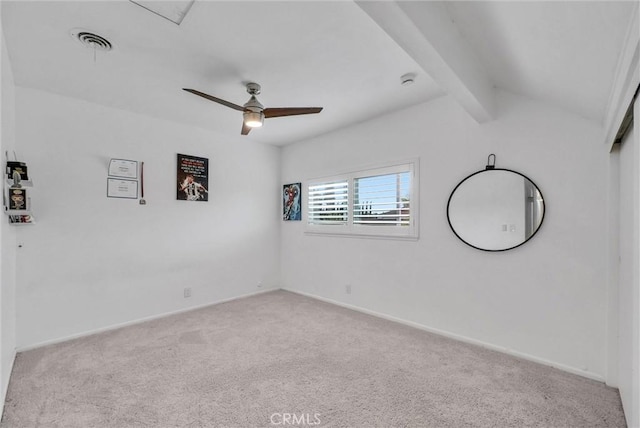 carpeted empty room with lofted ceiling with beams, baseboards, a ceiling fan, and visible vents