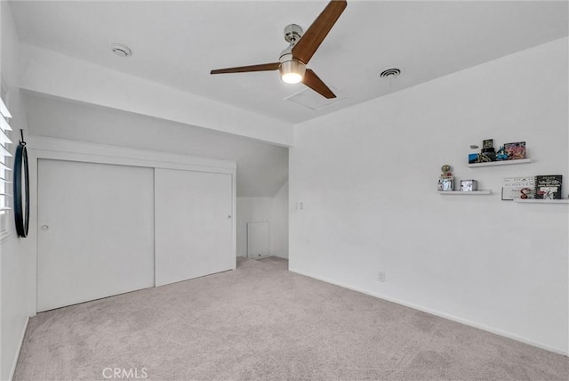 unfurnished bedroom with ceiling fan, carpet floors, visible vents, and a closet