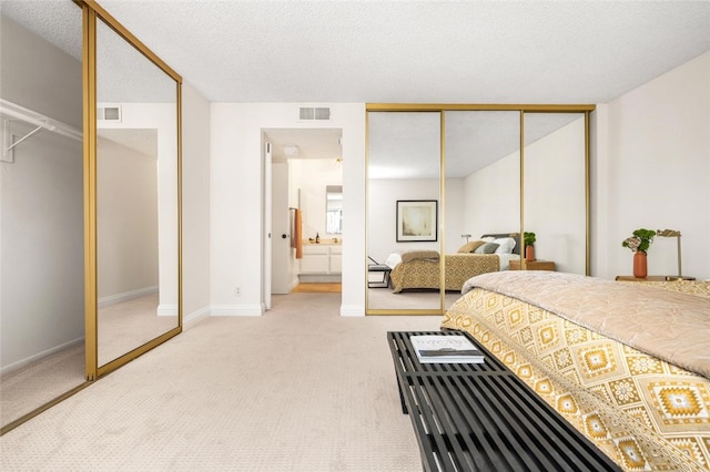 4050 Via Dolce Unit 241, Marina Del Rey, CA 90292 - bedroom featuring carpet, baseboards, ensuite bathroom, a closet, and a textured ceiling