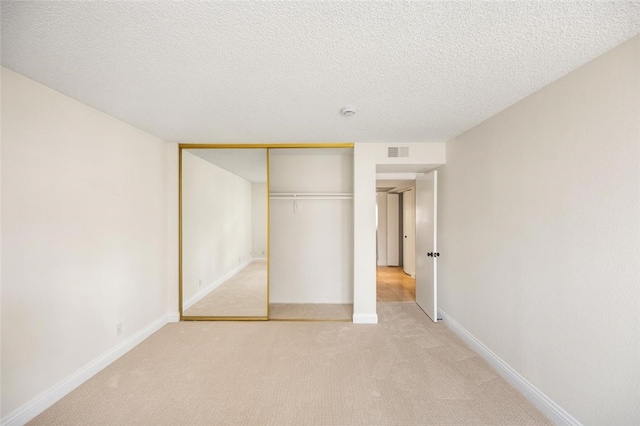 4050 Via Dolce Unit 241, Marina Del Rey, CA 90292 - unfurnished bedroom with light colored carpet, a closet, a textured ceiling, and baseboards