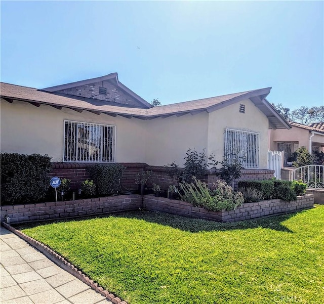 2912 Santa Ana St, South Gate, CA 90280 - view of side of home with a yard, brick siding, and stucco siding