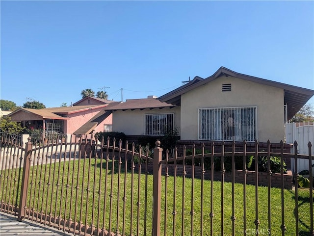 2912 Santa Ana St, South Gate, CA 90280 - view of front of house with a front lawn, stucco siding, and fence