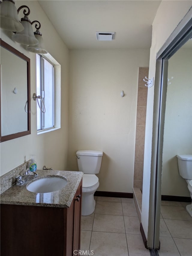 2912 Santa Ana St, South Gate, CA 90280 - bathroom featuring visible vents, tile patterned flooring, a shower stall, vanity, and toilet
