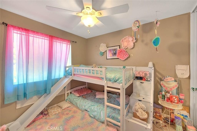 bedroom featuring multiple windows and a ceiling fan