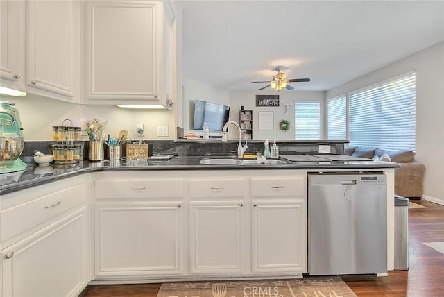 kitchen with dishwasher, a sink, ceiling fan, dark countertops, and white cabinetry
