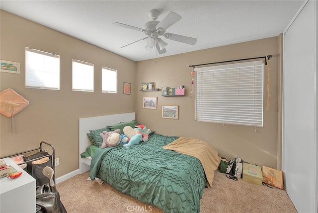 bedroom with carpet flooring, a ceiling fan, and baseboards