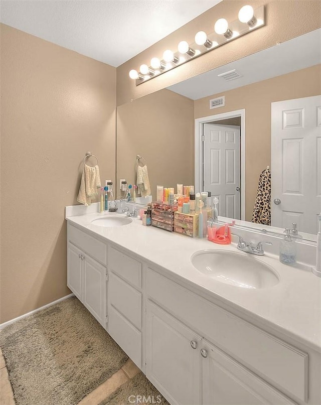 bathroom featuring double vanity and tile patterned floors